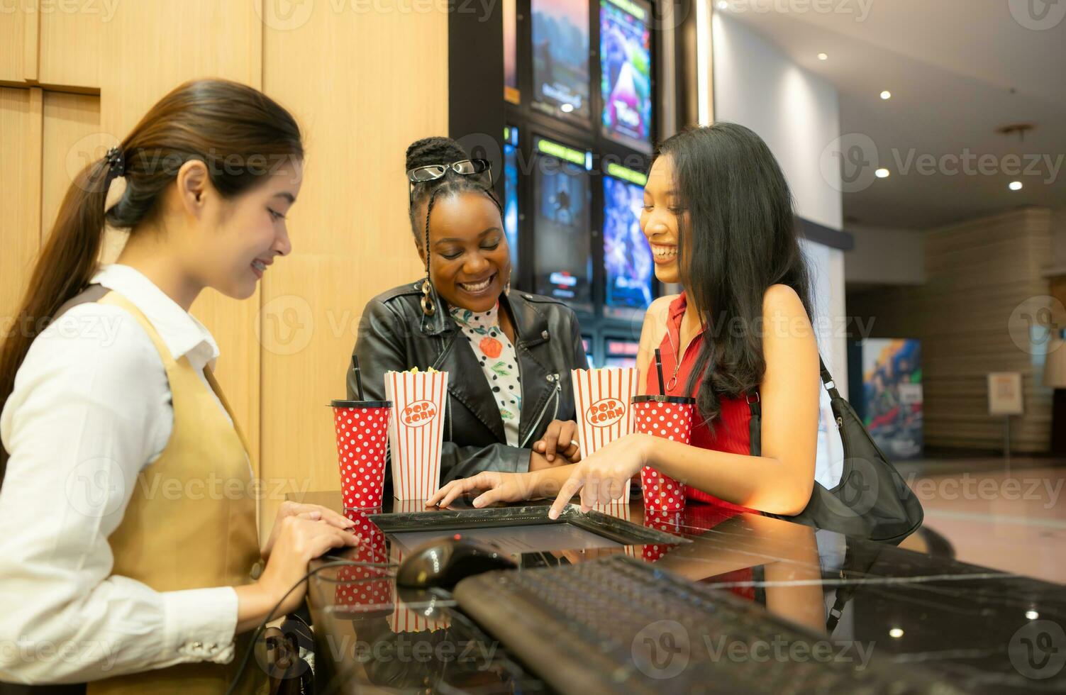 Asian ticket seller at the box office with the service of selling movie tickets to movie audiences in each round photo