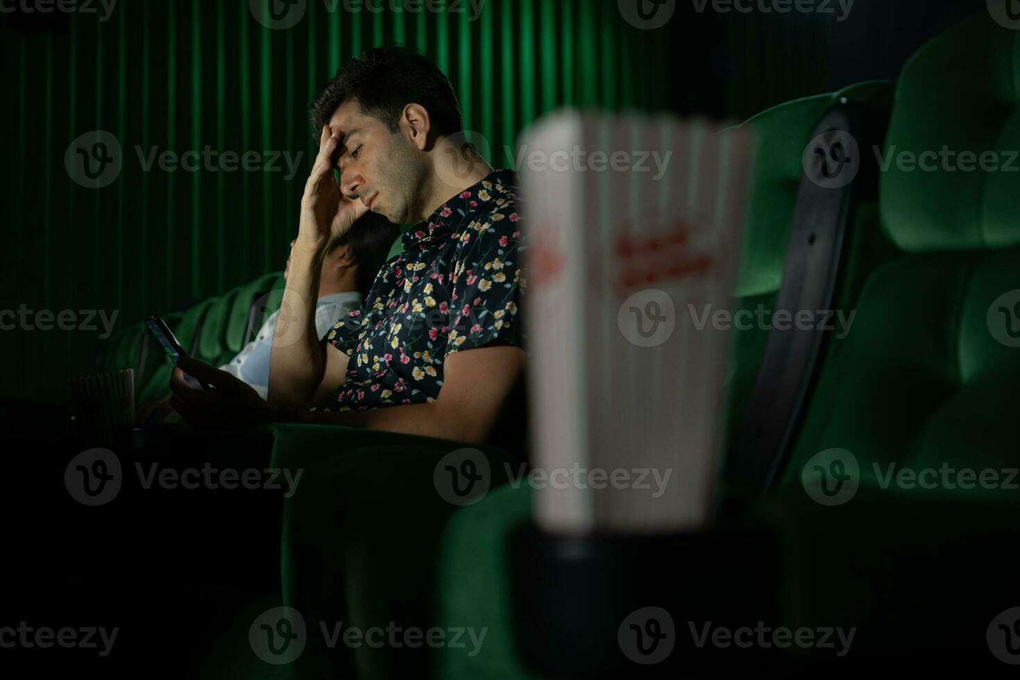 Cinema concept. People watching movie at cinema eating popcorn photo