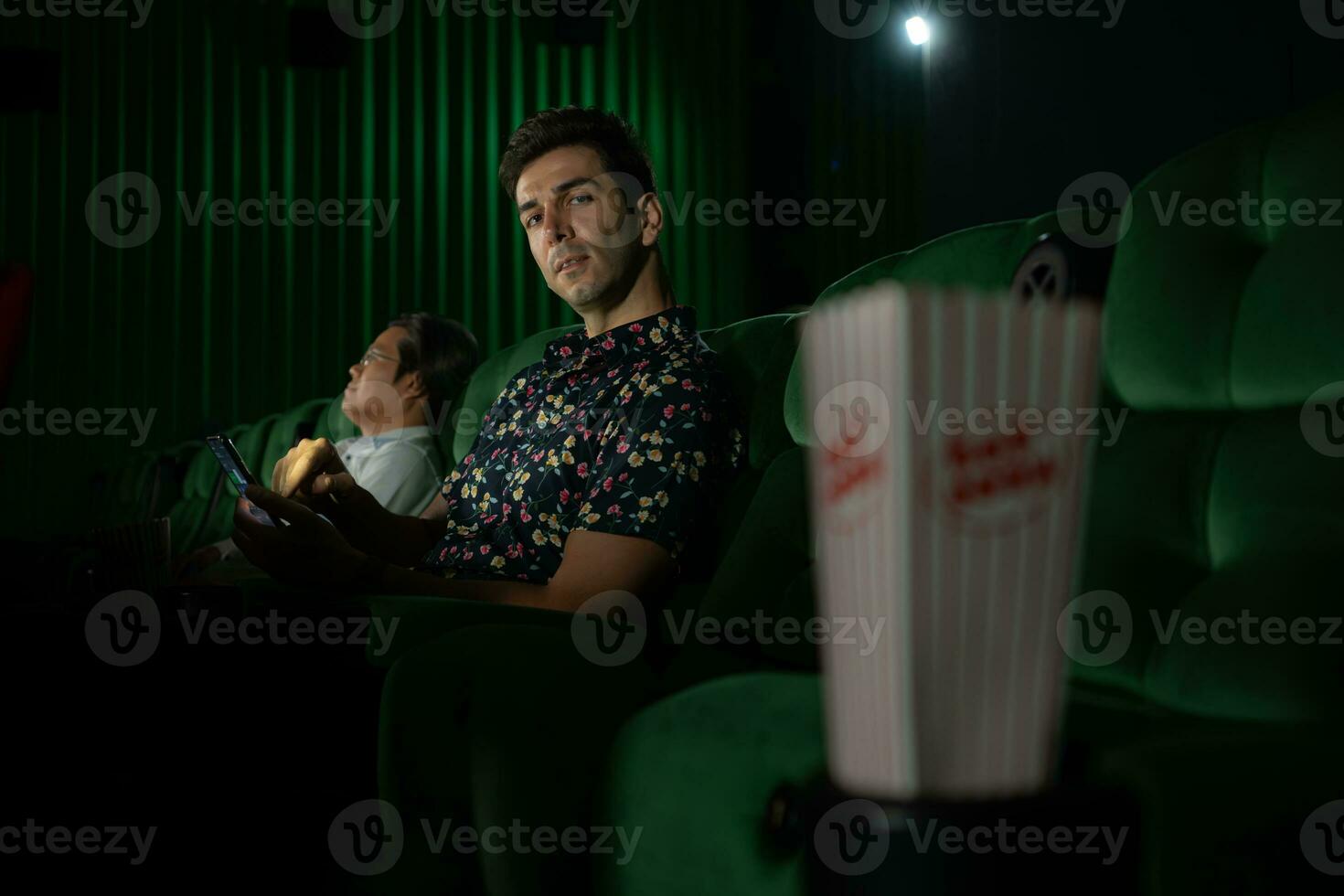 Cinema concept. People watching movie at cinema eating popcorn photo