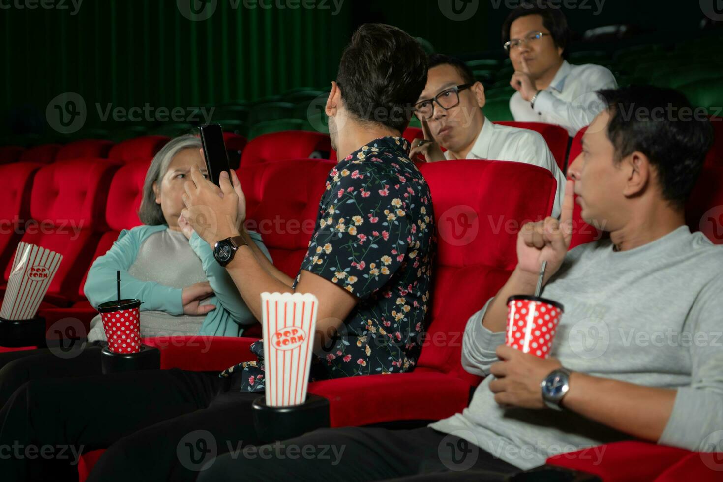 Movie etiquette, Do not talk on the phone while in the cinema, Group recreation and entertainment concept. photo