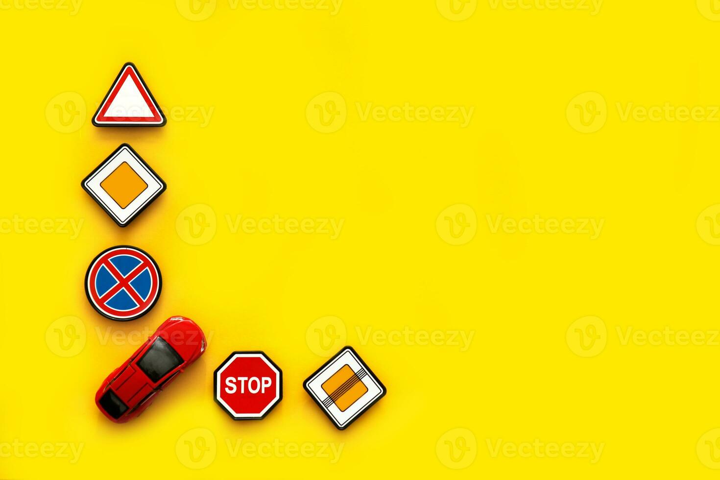 road signs with car on yellow background with copy space photo