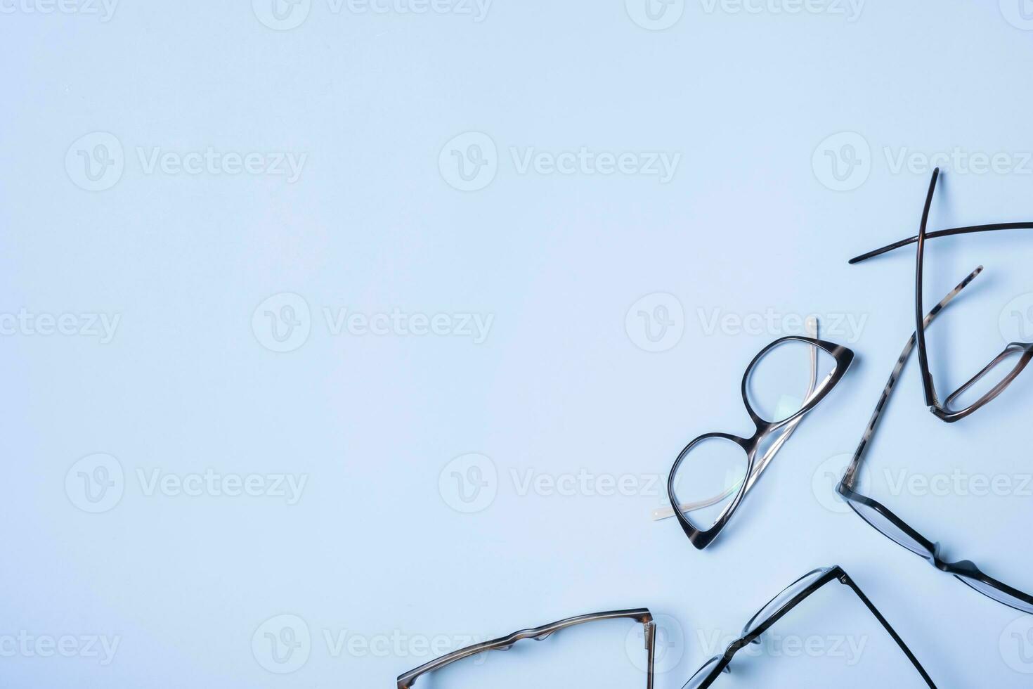 Eyeglasses on blue background with copy space. Optical store, vision test, stylish glasses concept photo