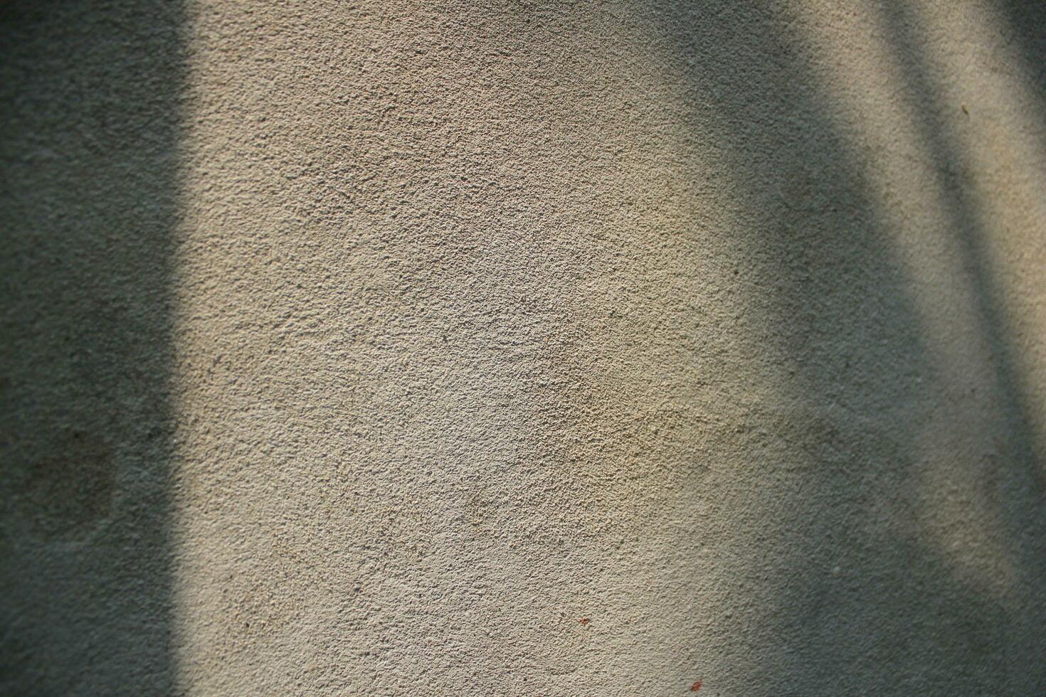 Cement and brick wall texture background, sun rays on the cement wall surface, smooth cement wall backdrop photo