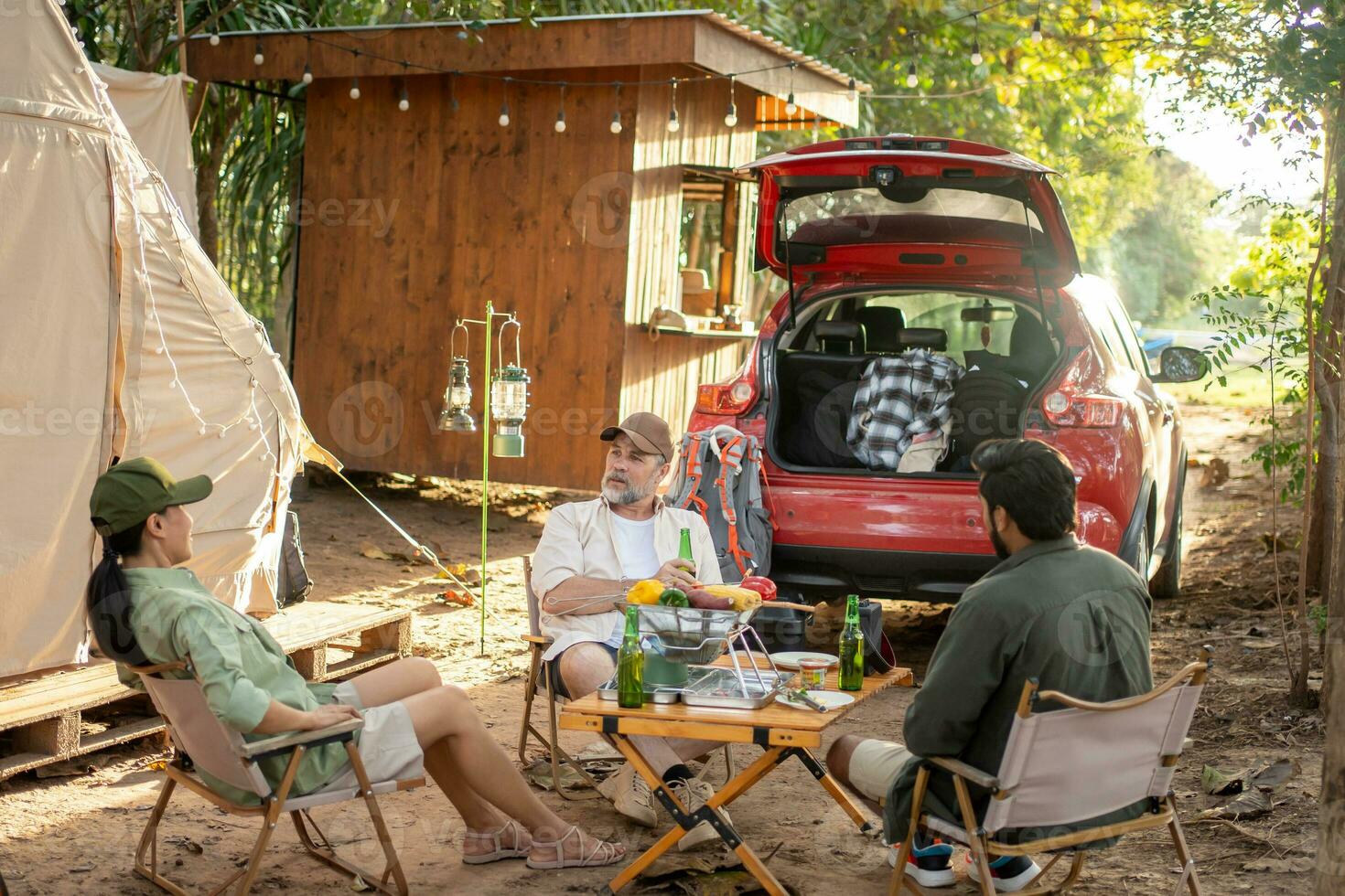 Group tourists drinking beer-alcohol and play guitar together with enjoy and happiness in Summer while camping photo