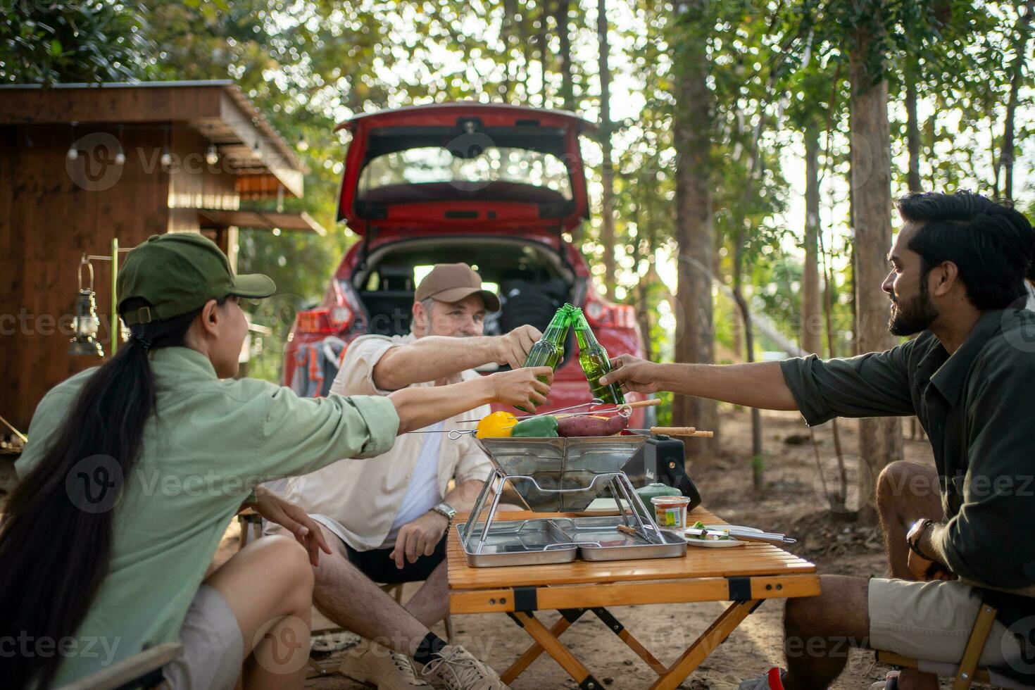 Group tourists drinking beer-alcohol and play guitar together with enjoy and happiness in Summer while camping photo