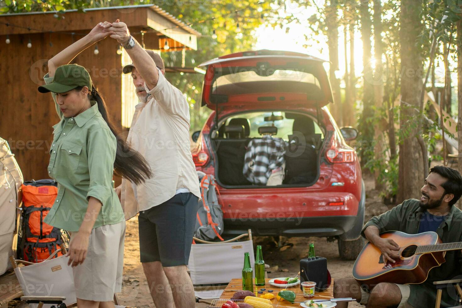 Group tourists drinking beer-alcohol and play guitar together with enjoy and happiness in Summer while camping photo