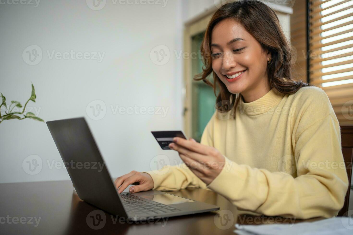 Women using Smart phone and Laptop for shopping online and payment with Credit card at home photo
