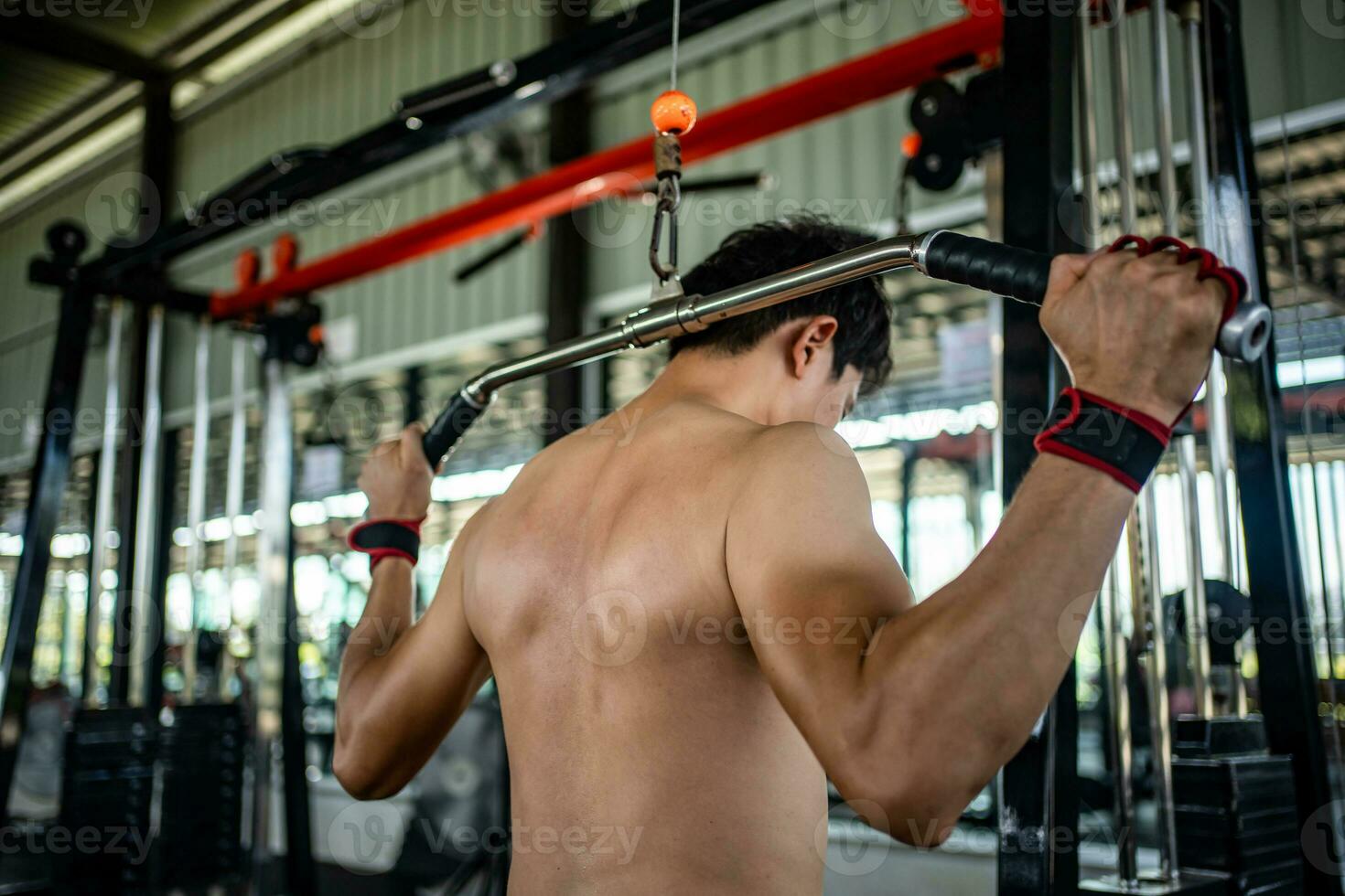 Man doing squat exercises with a barbell in gym photo
