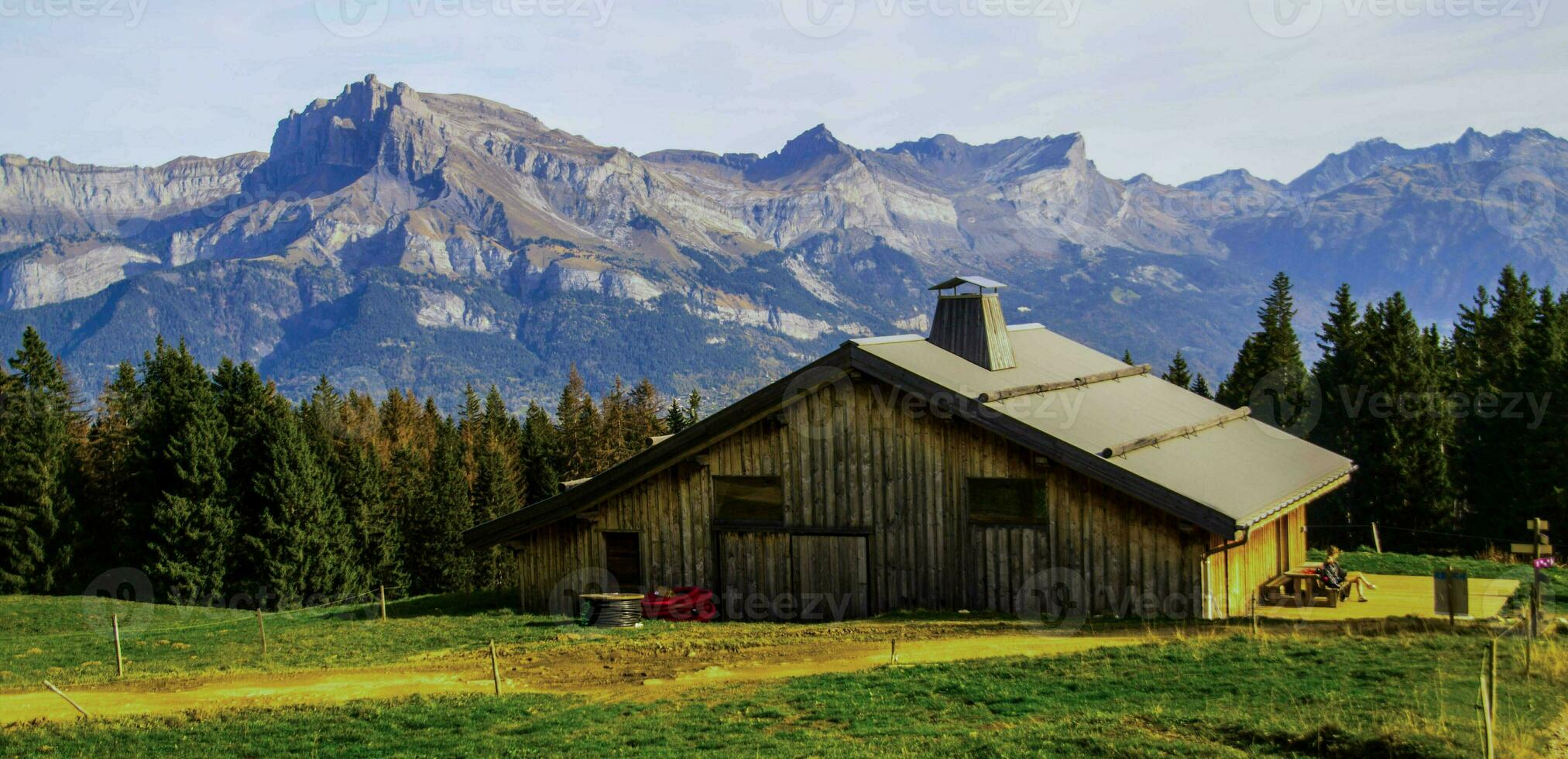 a cabin in the mountains with a mountain range in the background photo