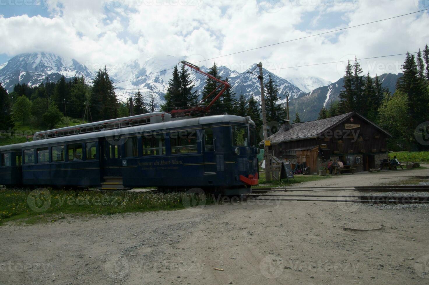 a blue train on the tracks photo