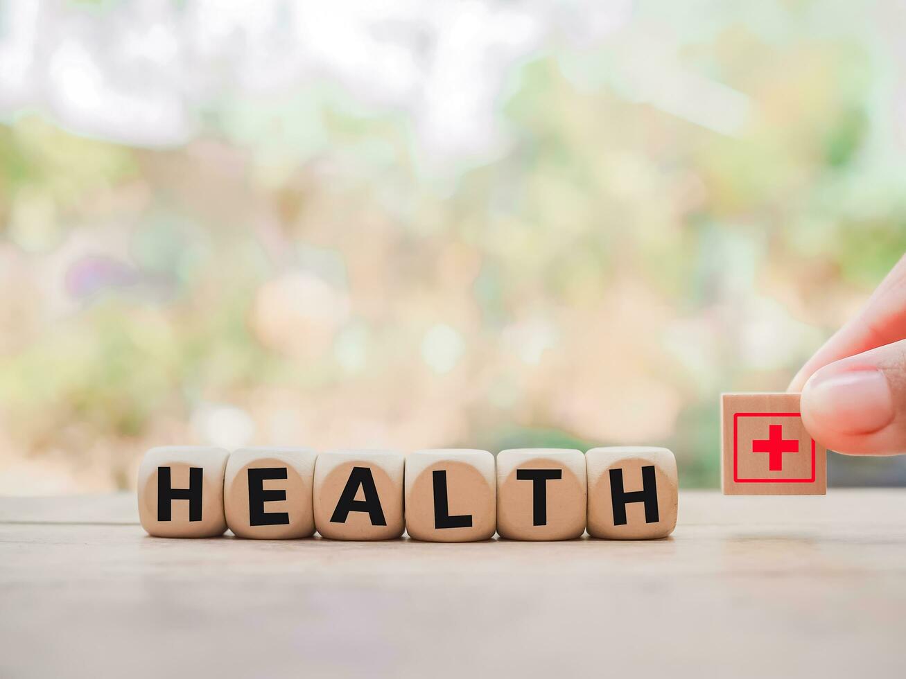 Wooden block with word HEALTH and health care or medical icon. photo