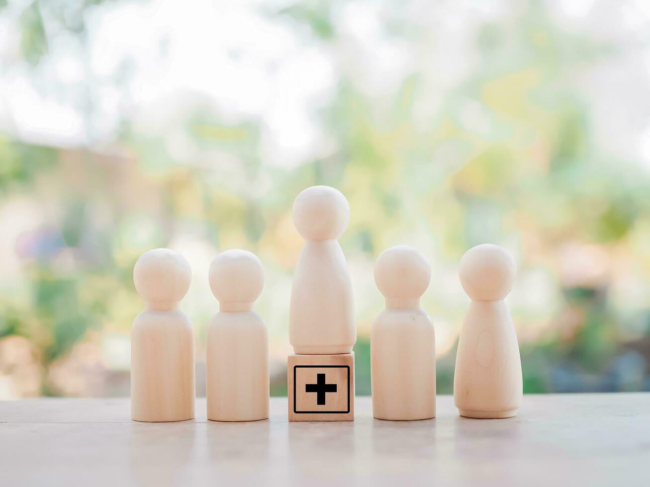 Wooden human figure and wooden block with health care and medical icons set. photo