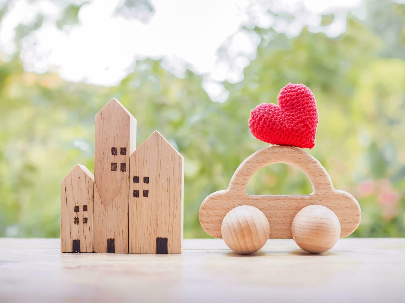Miniature house, Red heart and wooden toy car. Concept of family photo