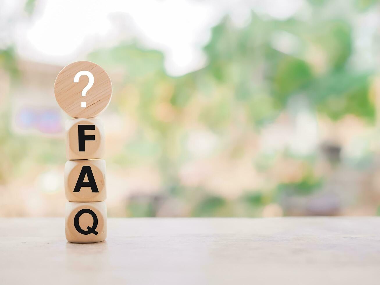 Wooden block with word the FAQ with question marks. The concept of question or answer time. photo