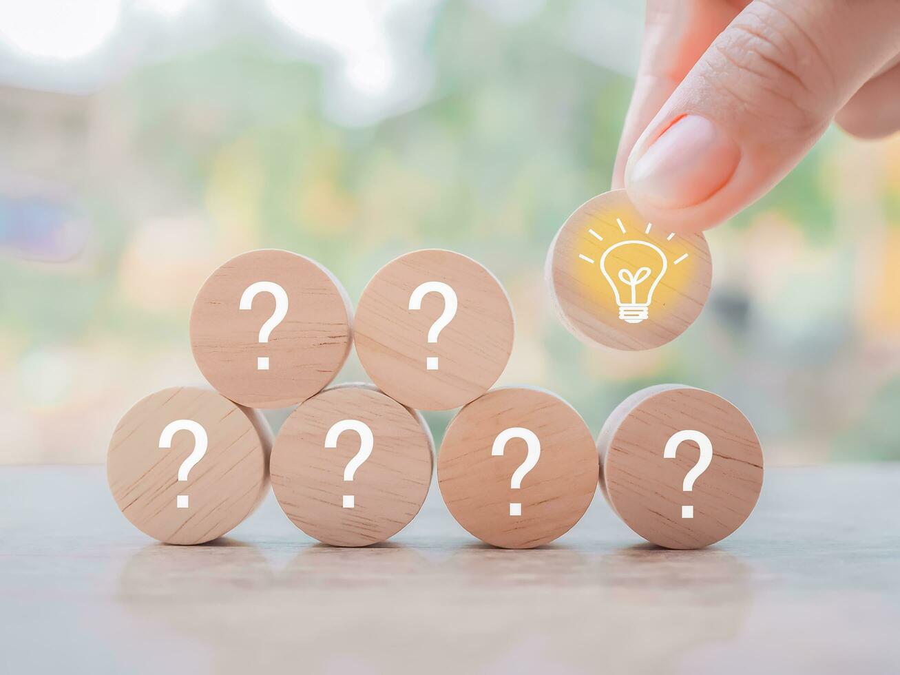 Close up hand arranging wooden block with light bulb and wooden block with question mark for leadership, creative, idea, innovation concept. photo