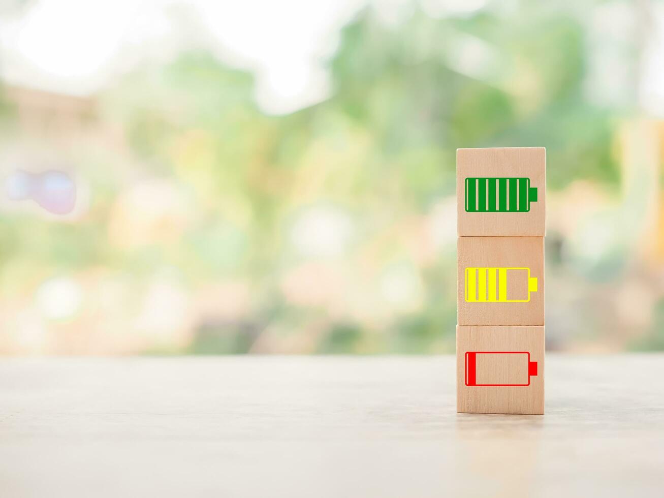 Wooden blocks with status of battery icons. photo