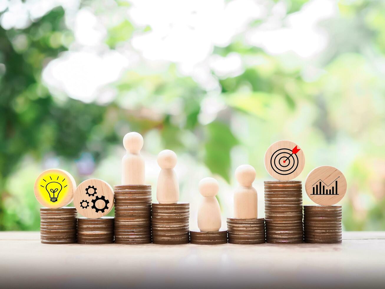 Wooden human figure standing on stack of coins with  business strategy icons, Action plan and business process management concept. photo