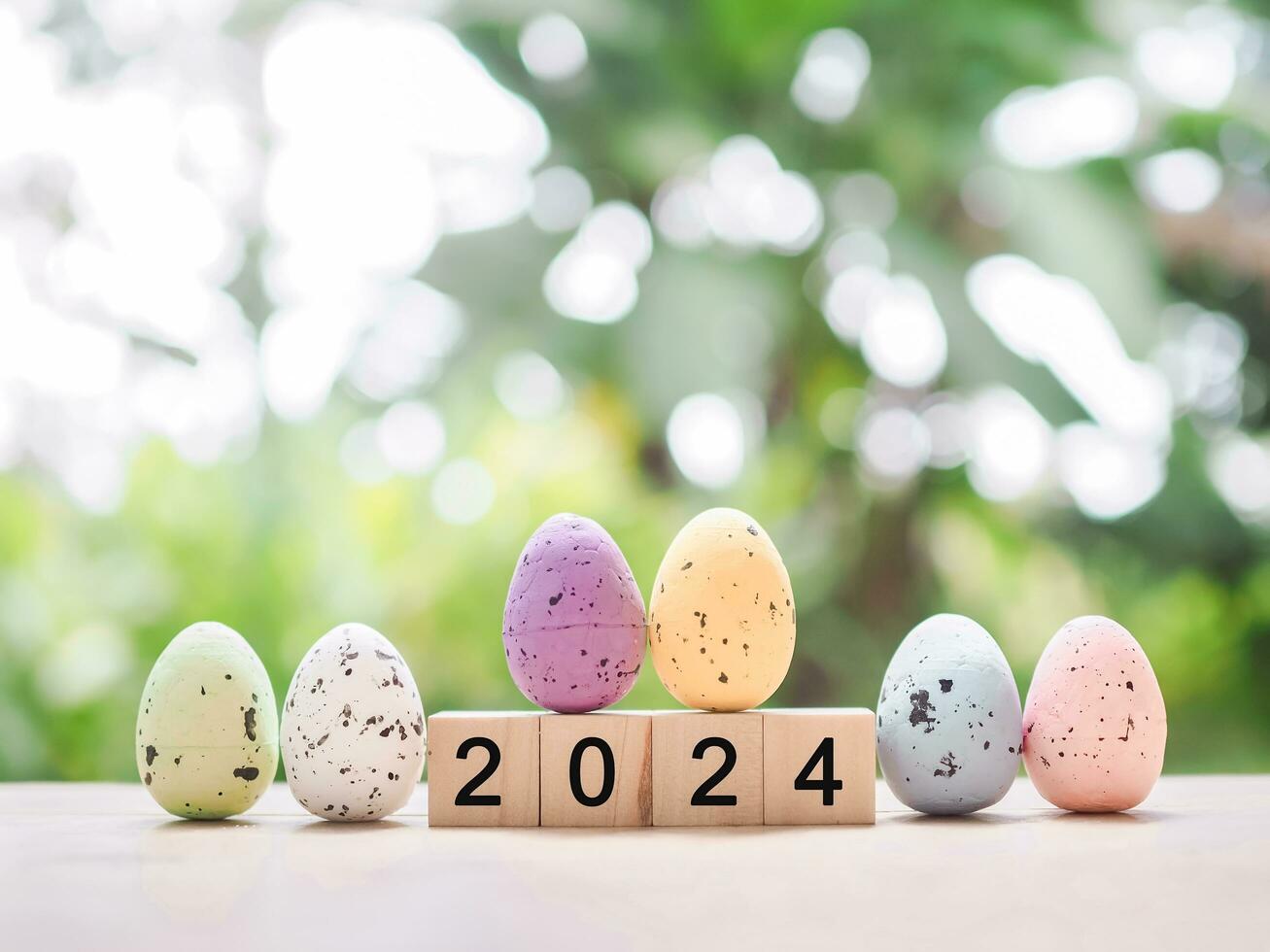 Easter eggs and wooden block with number 2024 for EASTER DAY in new