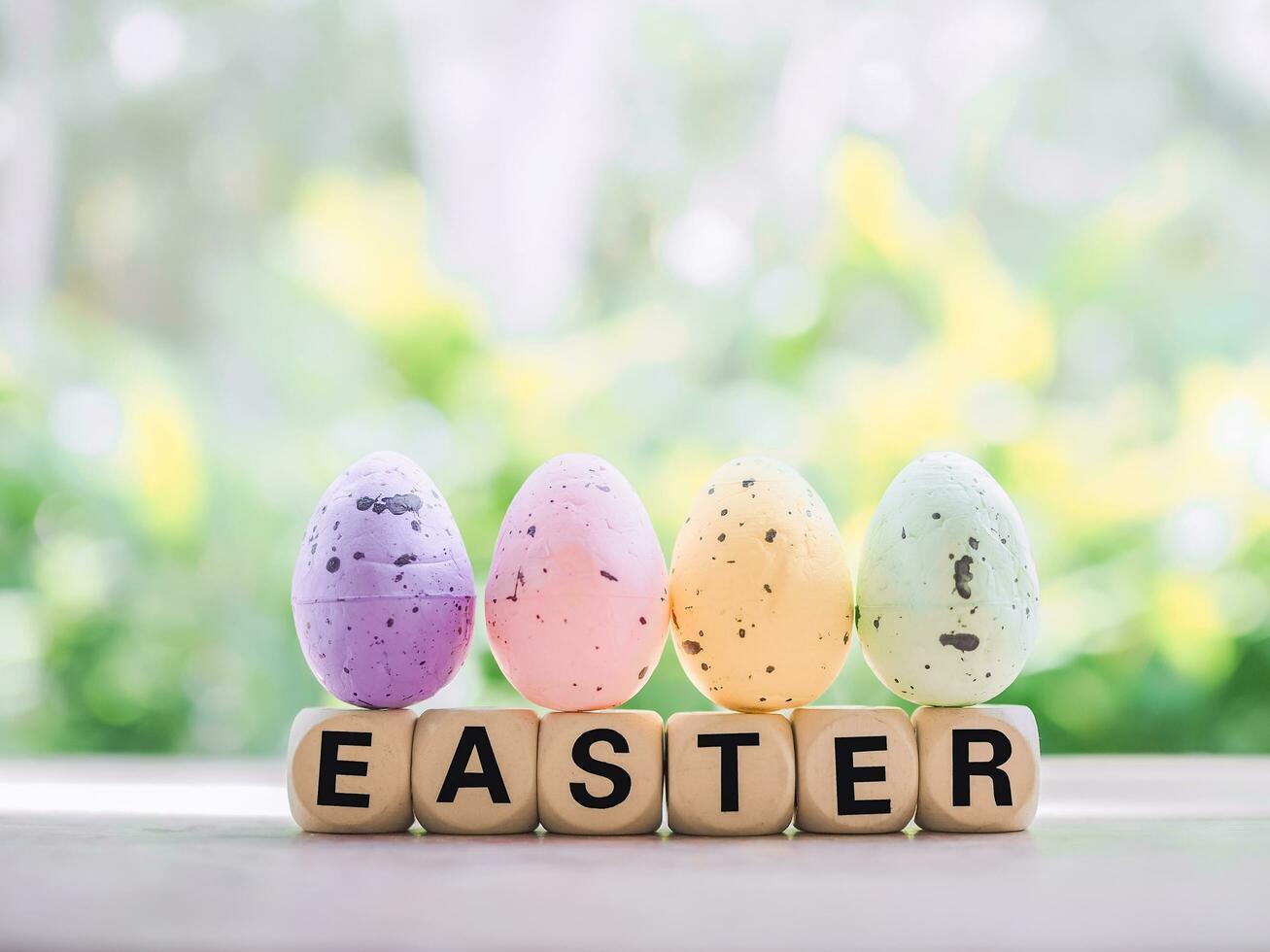 Wooden block with word HAPPY EASTER with colorful eggs for Easter day concept. photo