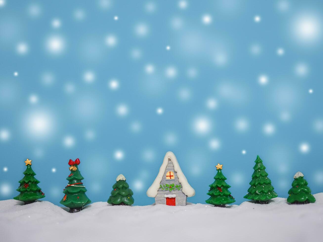 Christmas tree, Miniature house with shiny light for Christmas and New Year holidays background, Winter season, falling snow, Copy space for Christmas and New Year holidays greeting card. photo