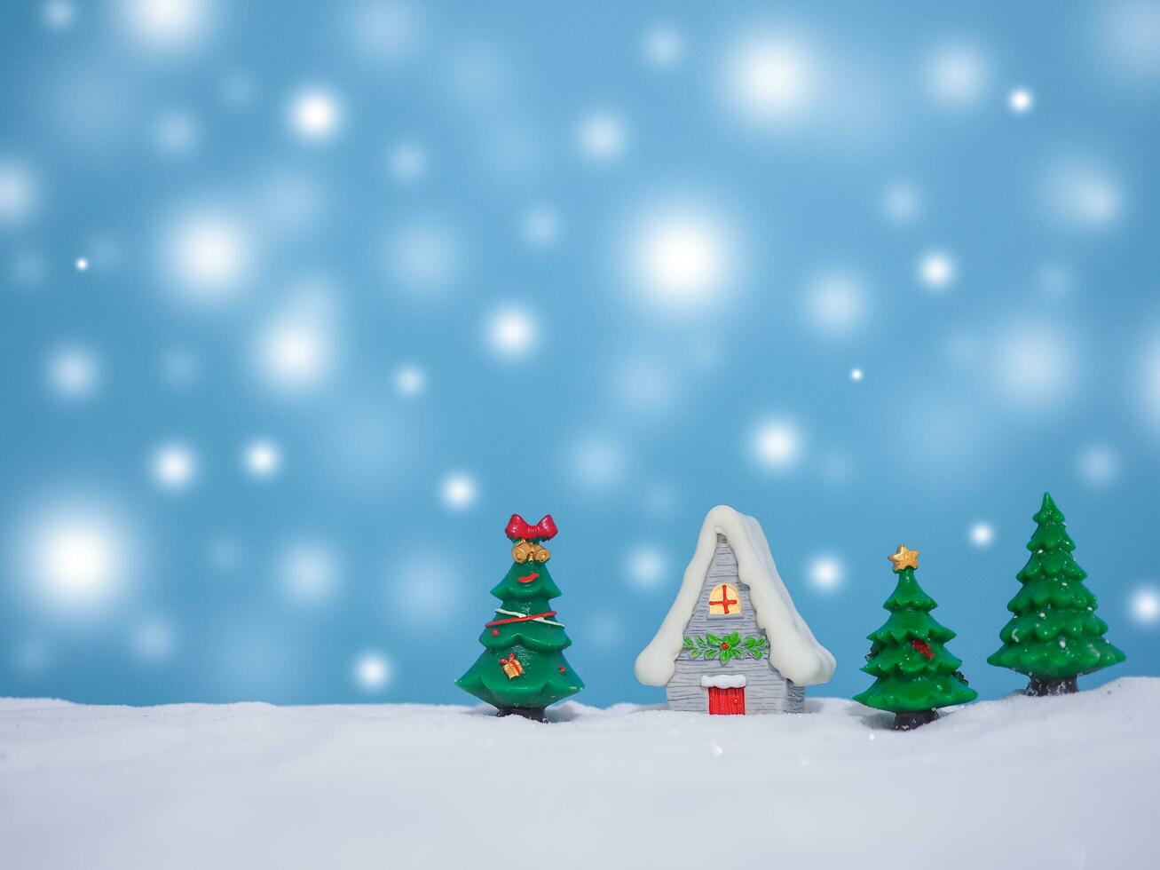 Christmas tree, Miniature house with shiny light for Christmas and New Year holidays background, Winter season, falling snow, Copy space for Christmas and New Year holidays greeting card. photo