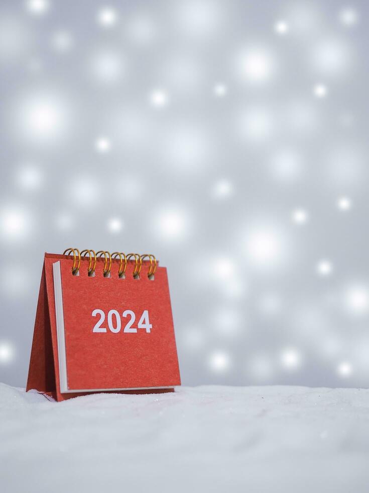 Close up calendar with shiny light for Christmas and New Year holidays background, Winter season, falling snow, Copy space for Christmas and New Year holidays greeting card. photo