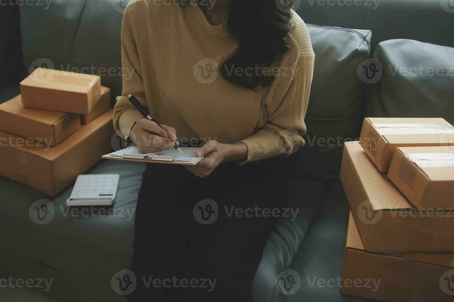 Business woman start up small business entrepreneur SME success .freelance woman working at home with Online Parcel delivery. SME and packaging deliveryconcept photo