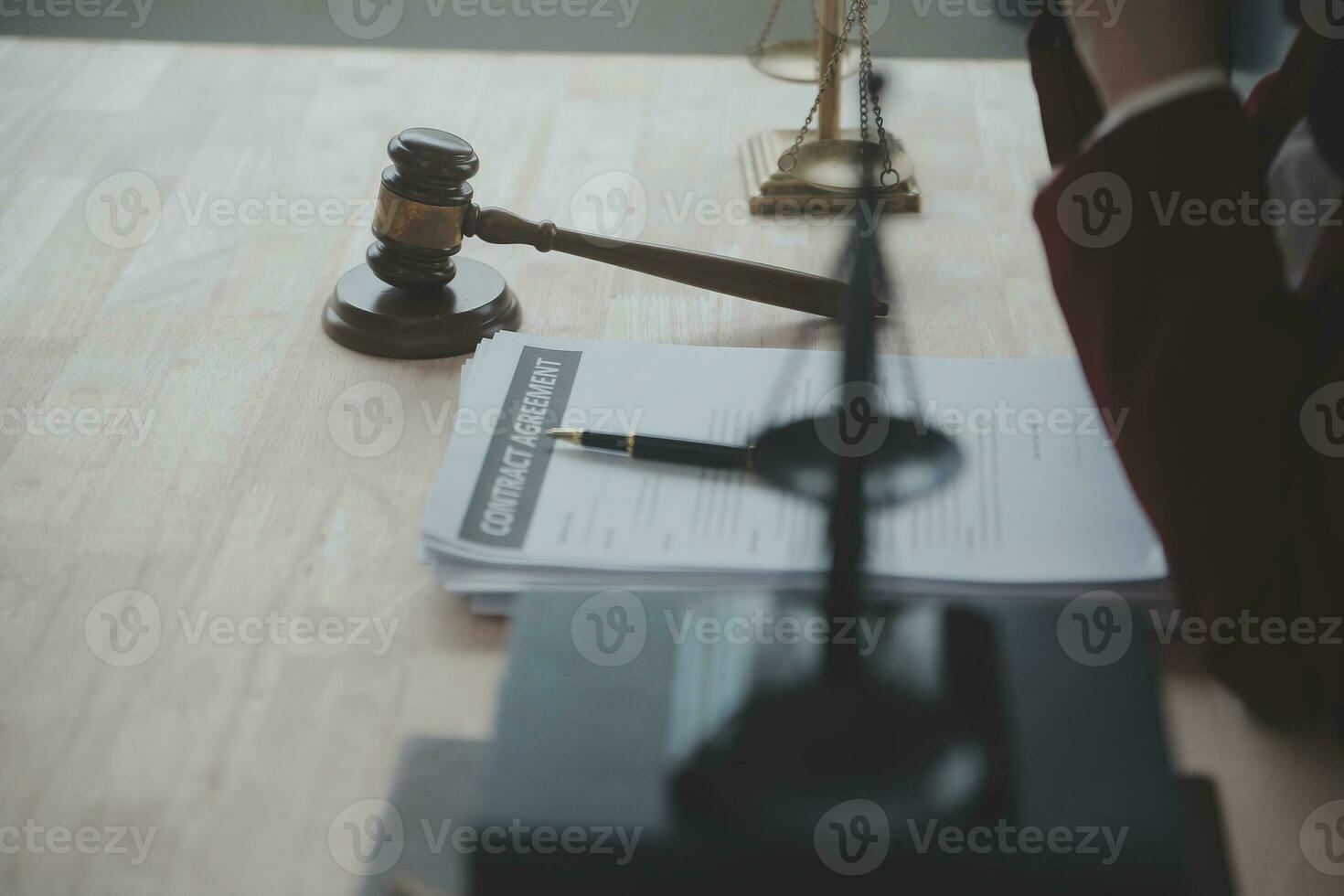 Business and lawyers discussing contract papers with brass scale on desk in office. Law, legal services, advice, justice and law concept picture with film grain effect photo
