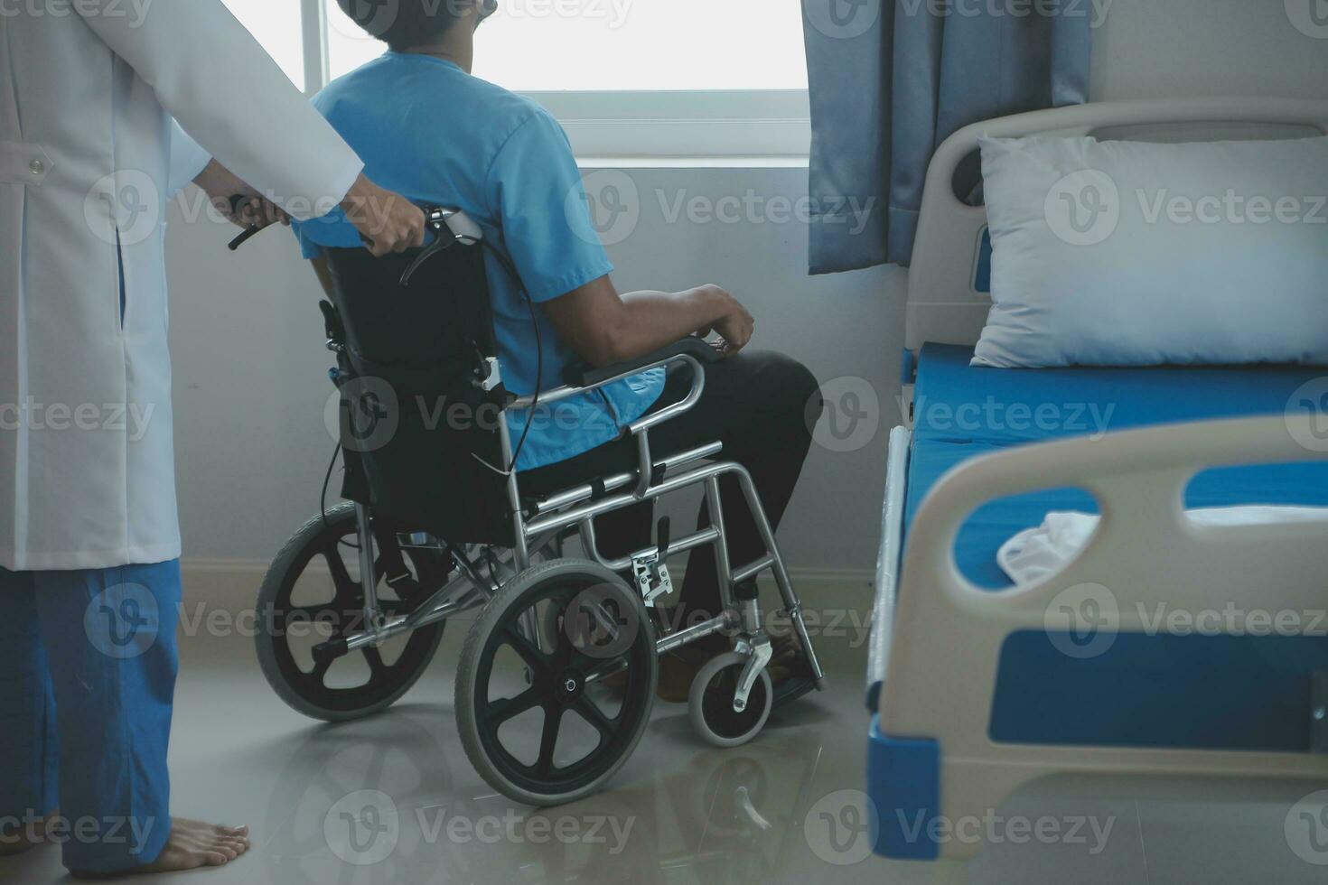 Depressed senior man sitting on the hospital bed alone at night, he feels lonely and abandoned photo