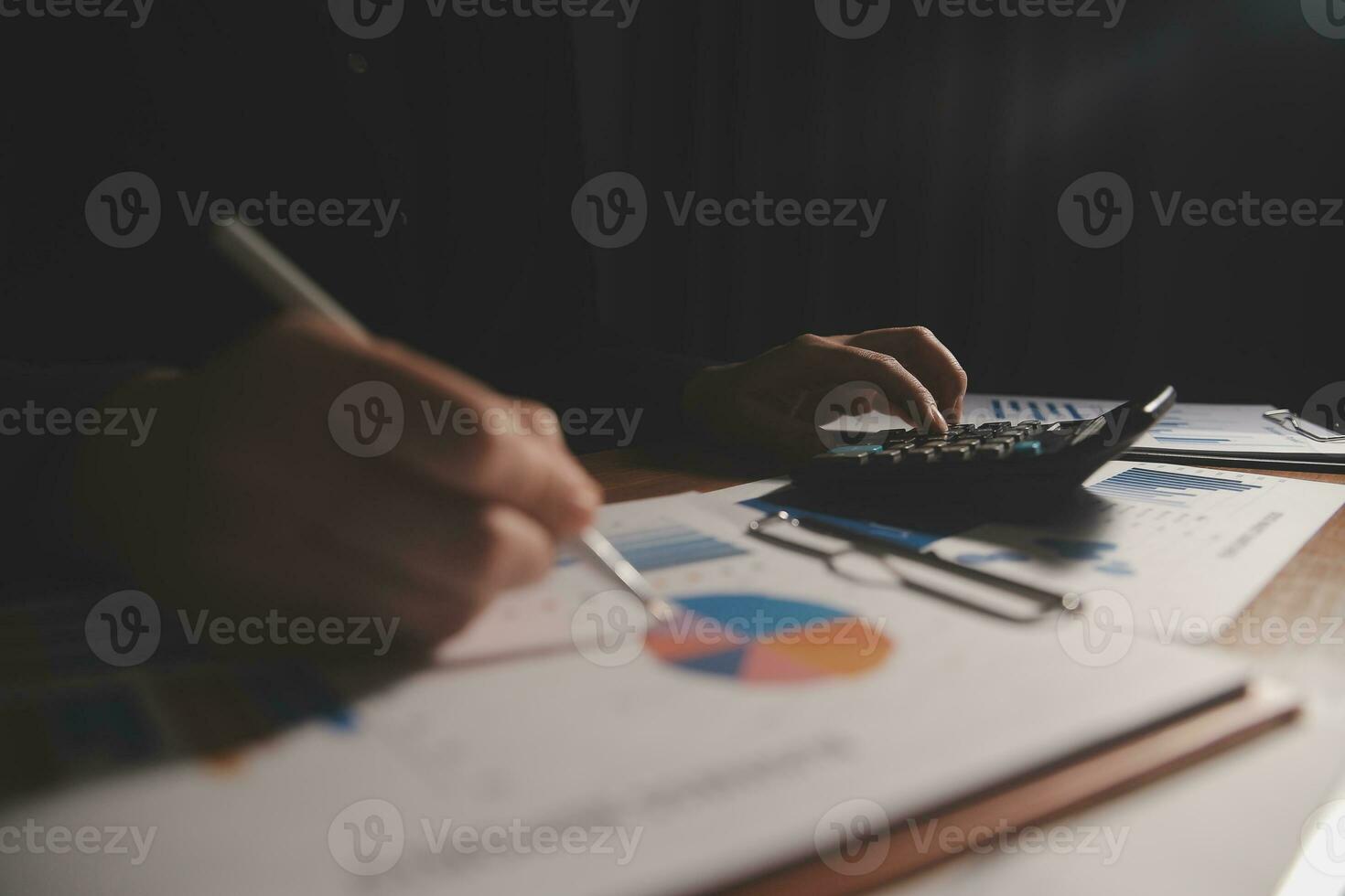 Close up businessman hand using calculator and working with laptop calculate about finance accounting at coffeeshop outdor.finance accounting concept photo