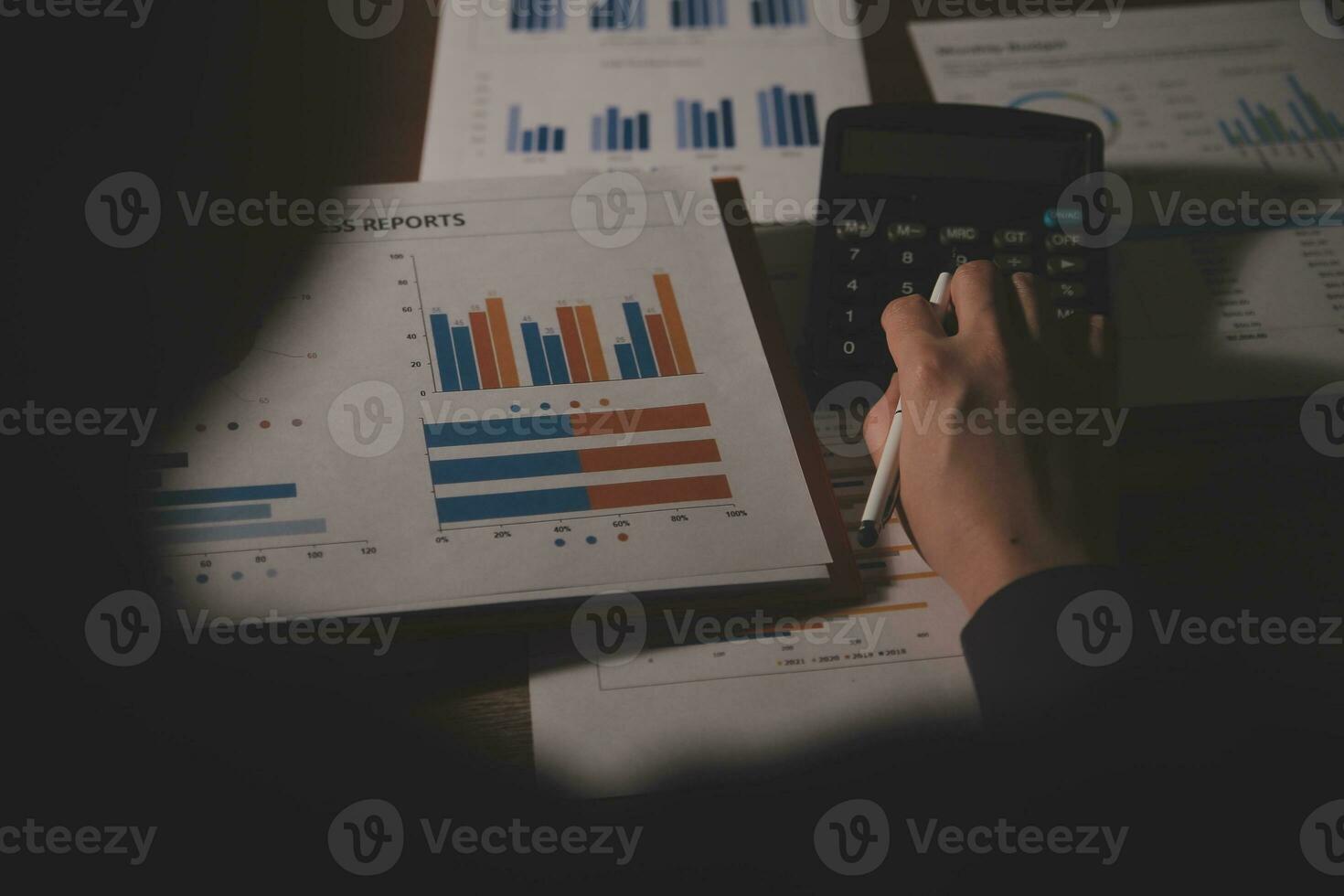 Close up businessman hand using calculator and working with laptop calculate about finance accounting at coffeeshop outdor.finance accounting concept photo