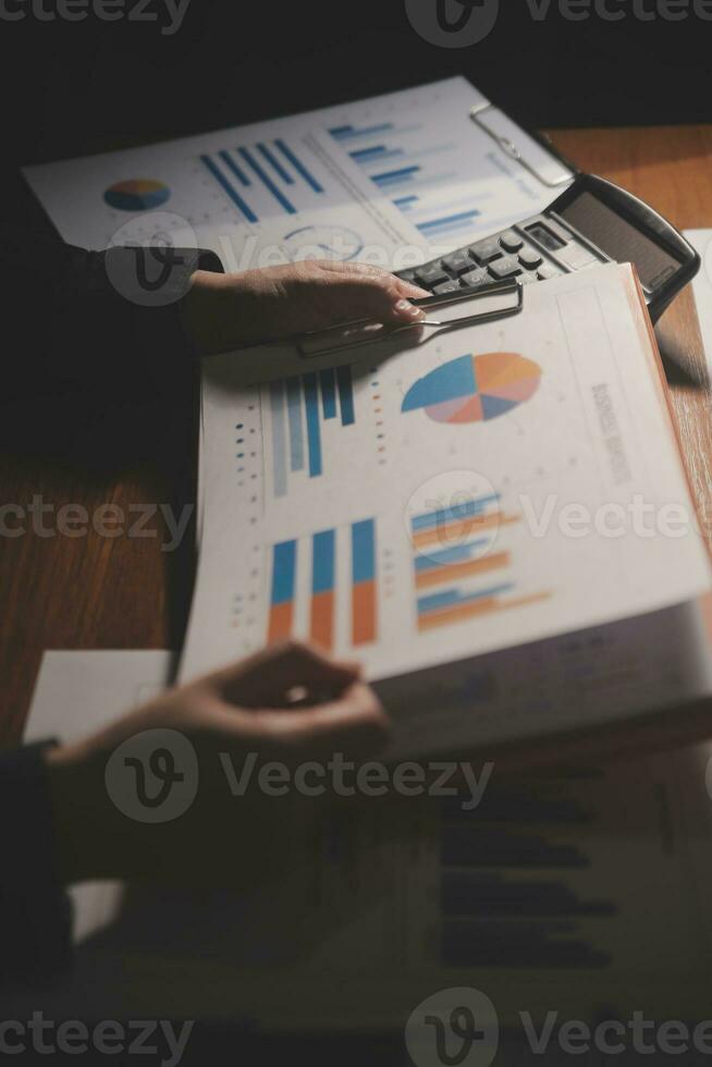 Close up businessman hand using calculator and working with laptop calculate about finance accounting at coffeeshop outdor.finance accounting concept photo