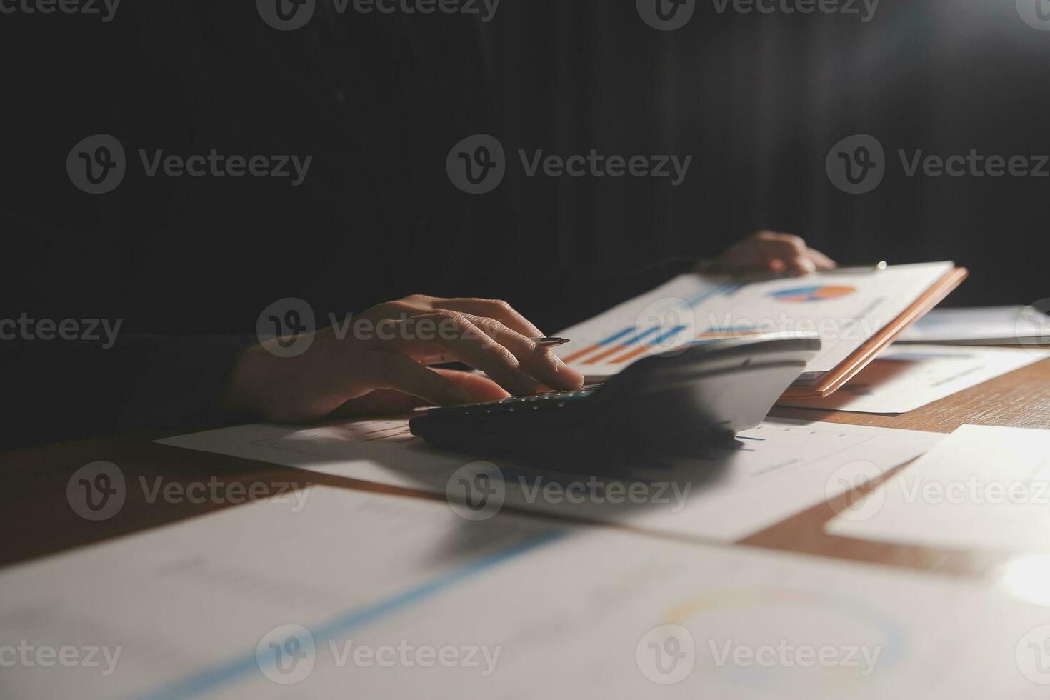 Close up businessman hand using calculator and working with laptop calculate about finance accounting at coffeeshop outdor.finance accounting concept photo