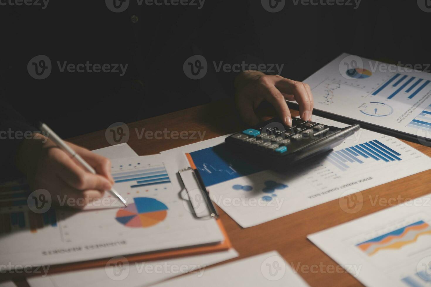 Close up businessman hand using calculator and working with laptop calculate about finance accounting at coffeeshop outdor.finance accounting concept photo