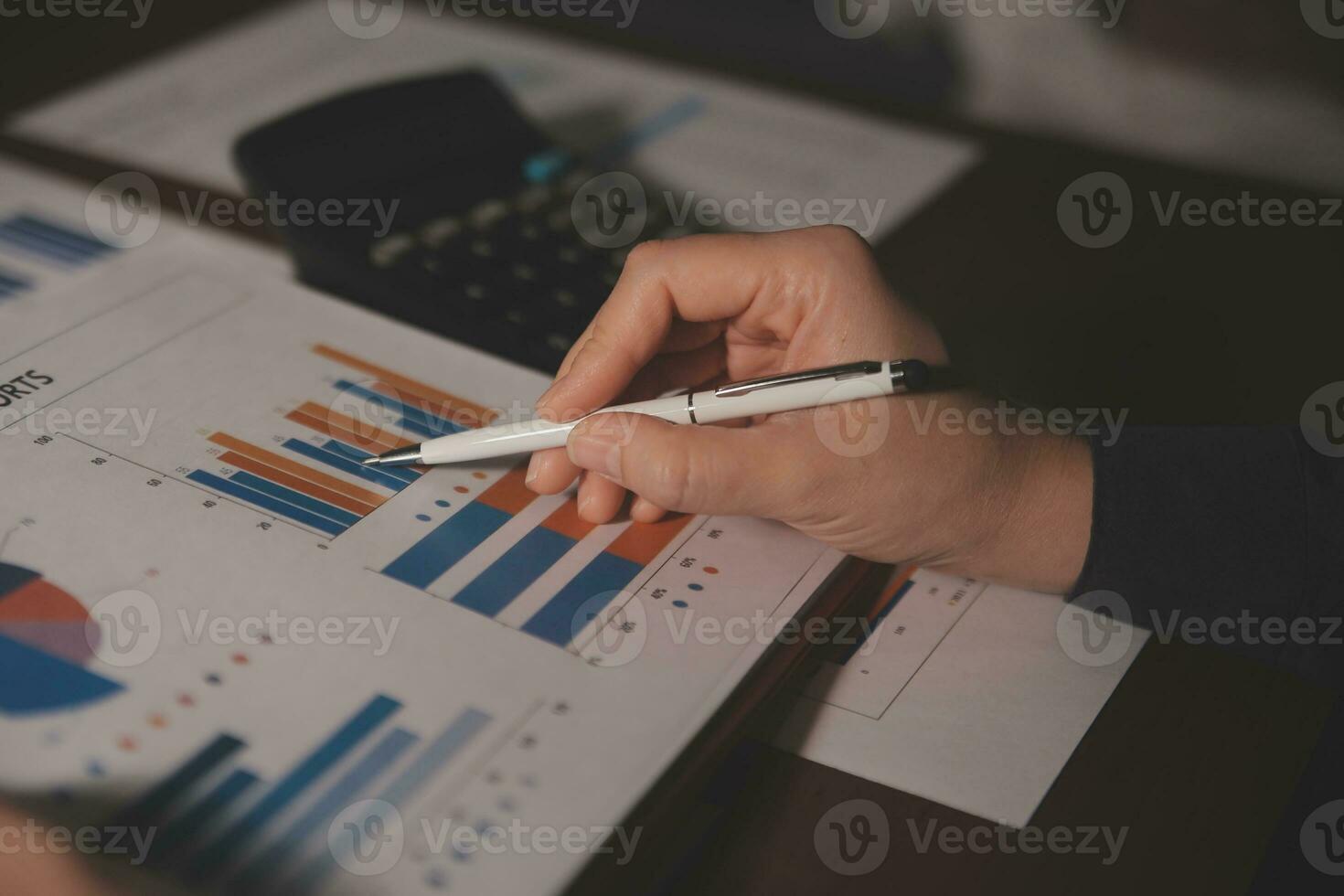 Close up businessman hand using calculator and working with laptop calculate about finance accounting at coffeeshop outdor.finance accounting concept photo
