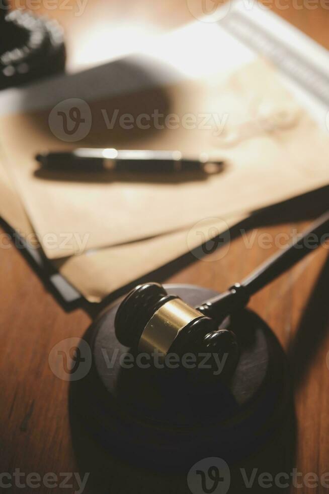 Business and lawyers discussing contract papers with brass scale on desk in office. Law, legal services, advice, justice and law concept picture with film grain effect photo