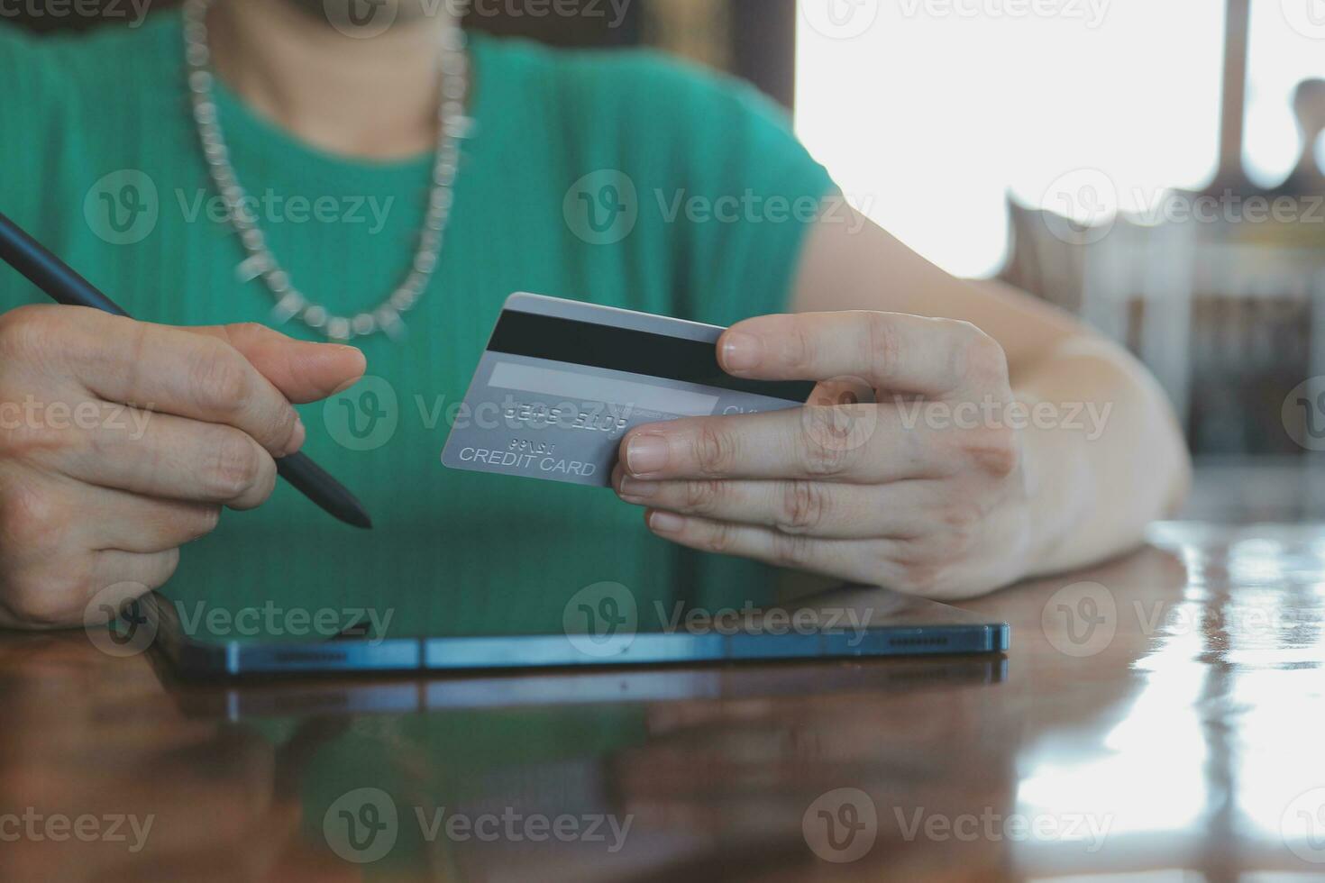 Woman is holding credit card and using laptop computer. Online shopping concept. Close up. photo