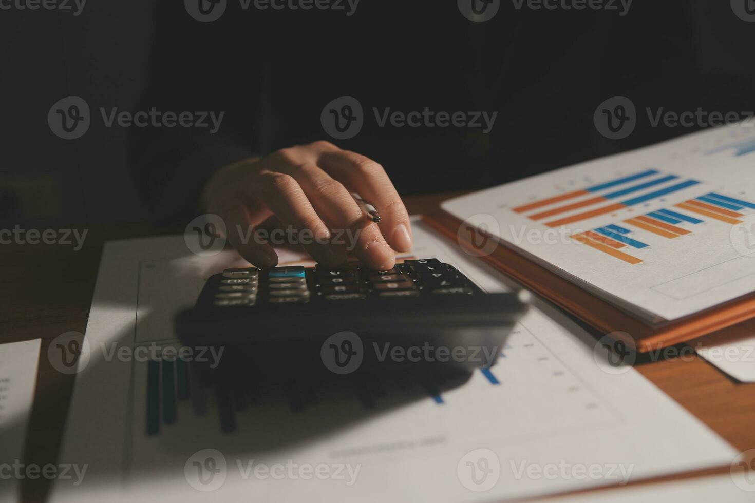 Close up businessman hand using calculator and working with laptop calculate about finance accounting at coffeeshop outdor.finance accounting concept photo