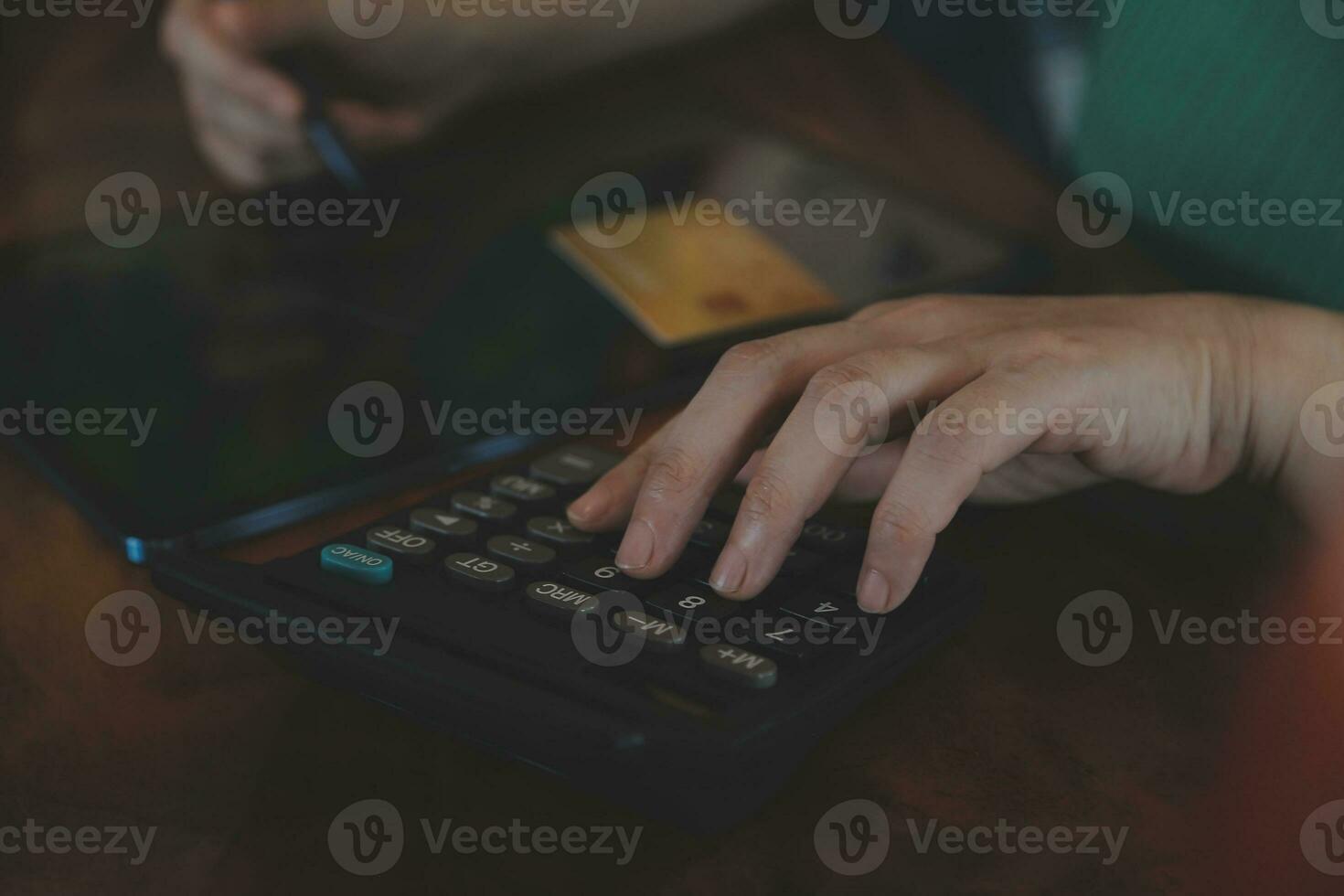 Close up businessman hand using calculator and working with laptop calculate about finance accounting at coffeeshop outdor.finance accounting concept photo