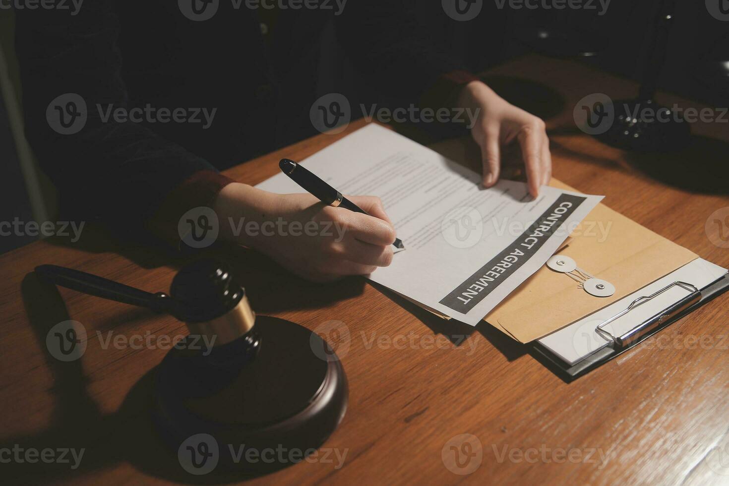 Business and lawyers discussing contract papers with brass scale on desk in office. Law, legal services, advice, justice and law concept picture with film grain effect photo