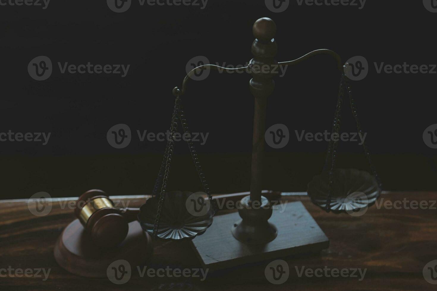 Justice and law concept.Male judge in a courtroom with the gavel, working with, computer and docking keyboard, eyeglasses, on table in morning light photo