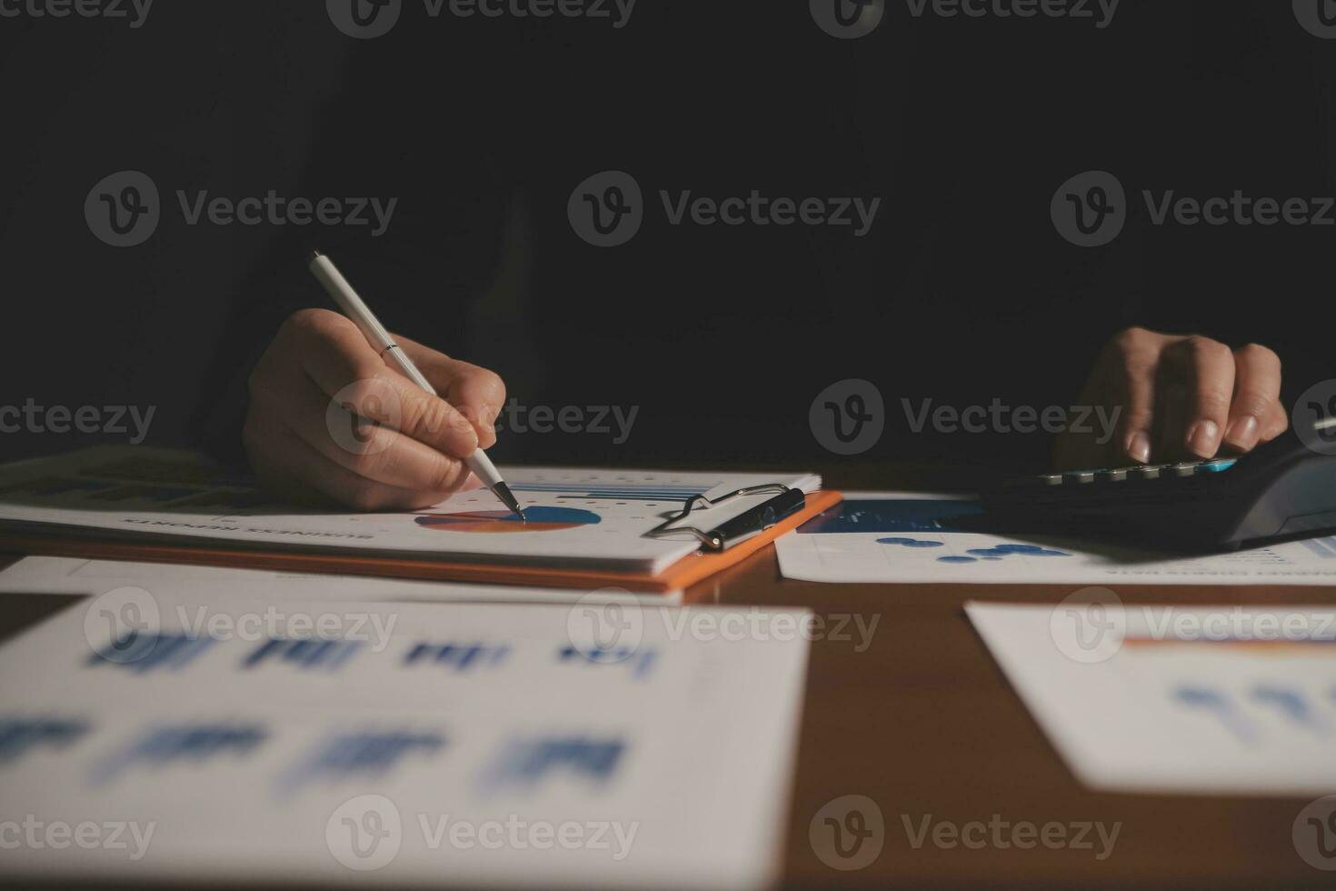Close up businessman hand using calculator and working with laptop calculate about finance accounting at coffeeshop outdor.finance accounting concept photo