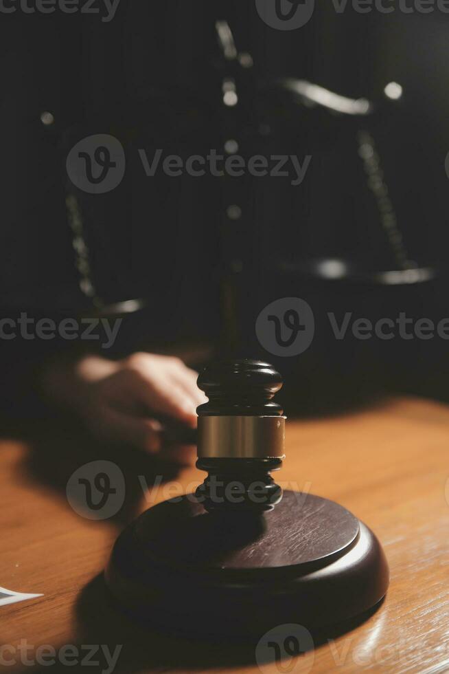 Business and lawyers discussing contract papers with brass scale on desk in office. Law, legal services, advice, justice and law concept picture with film grain effect photo