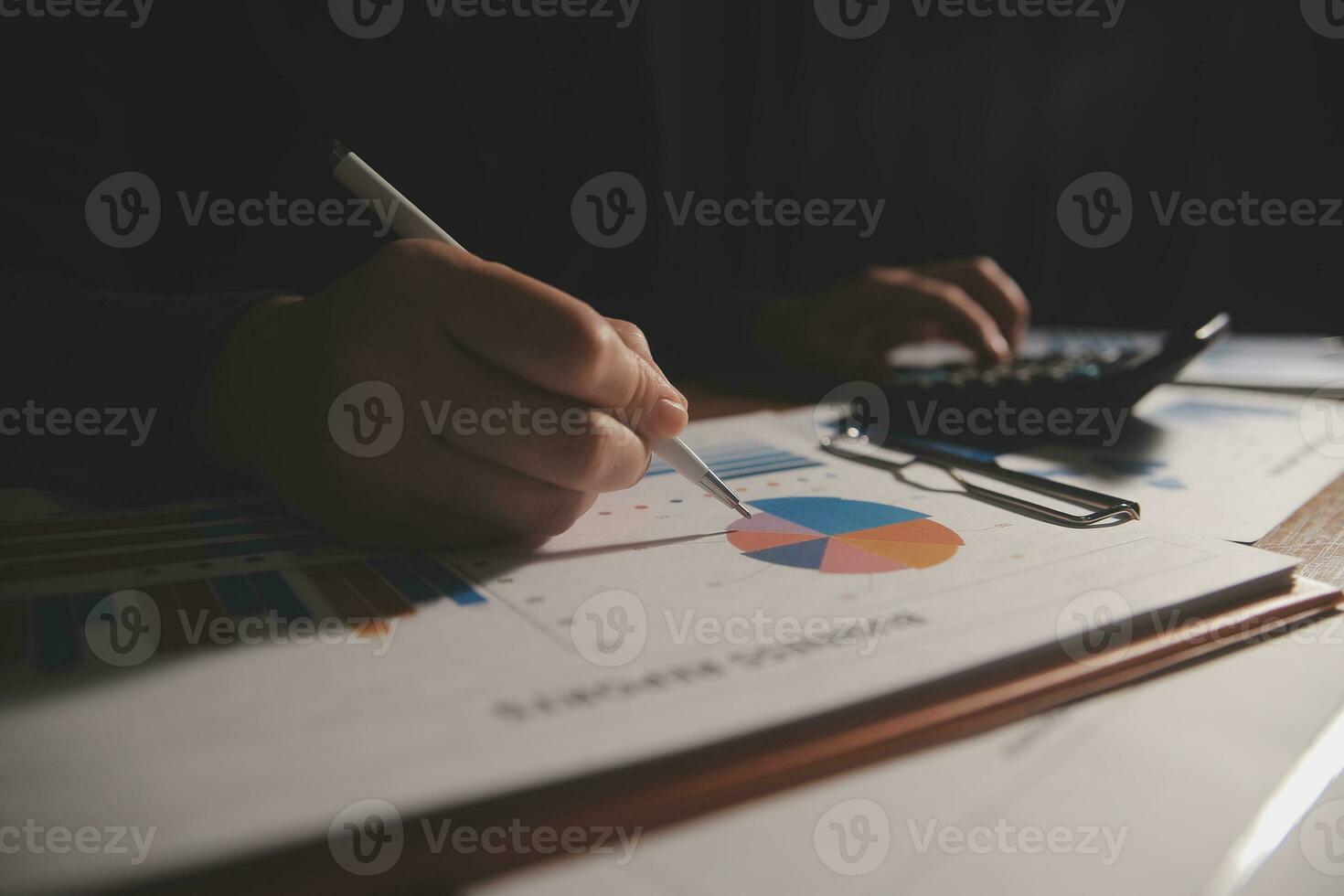 Close up businessman hand using calculator and working with laptop calculate about finance accounting at coffeeshop outdor.finance accounting concept photo