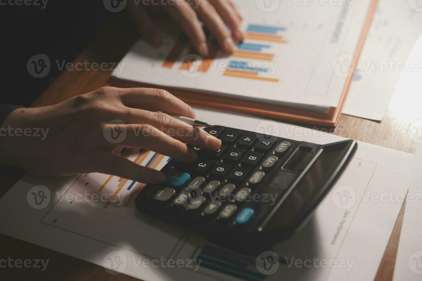 Close up businessman hand using calculator and working with laptop calculate about finance accounting at coffeeshop outdor.finance accounting concept photo