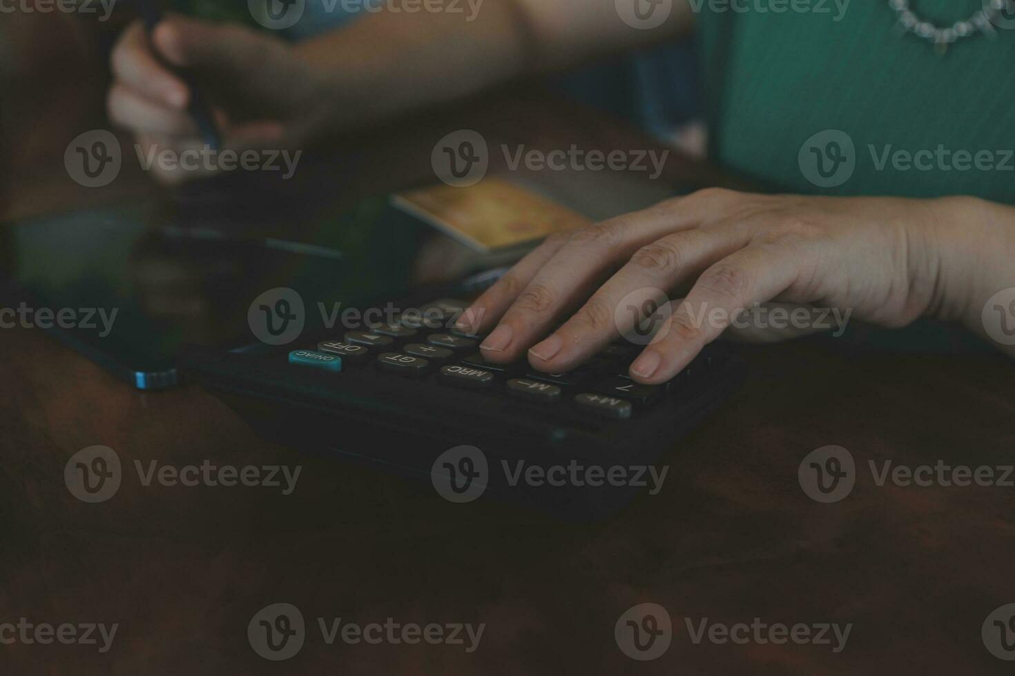 Close up businessman hand using calculator and working with laptop calculate about finance accounting at coffeeshop outdor.finance accounting concept photo