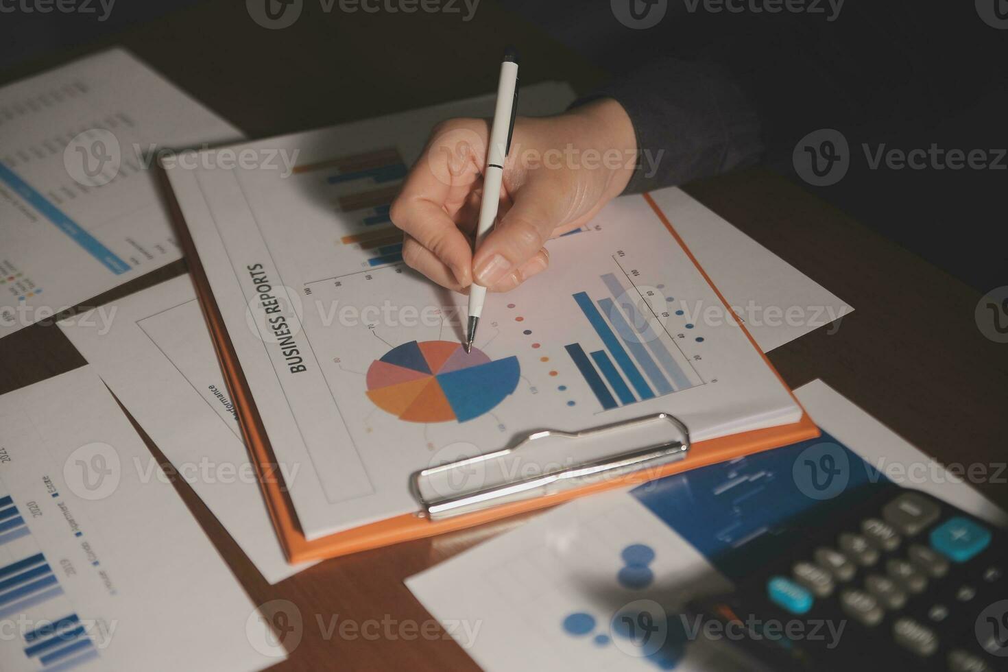 Close up businessman hand using calculator and working with laptop calculate about finance accounting at coffeeshop outdor.finance accounting concept photo