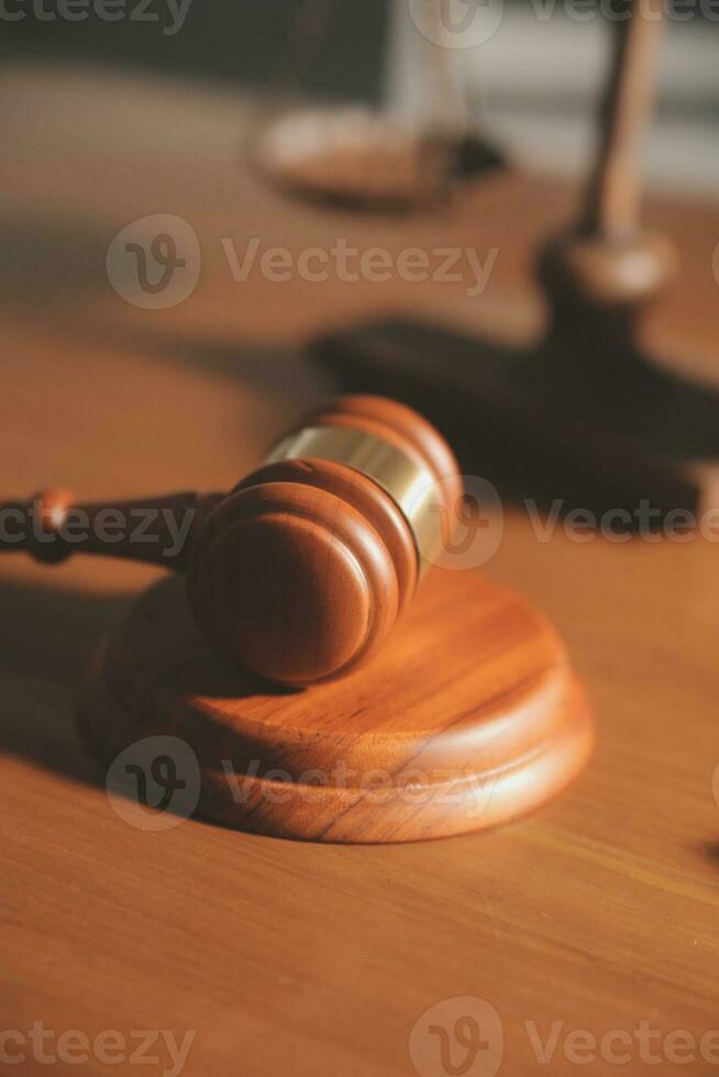 Business and lawyers discussing contract papers with brass scale on desk in office. Law, legal services, advice, justice and law concept picture with film grain effect photo