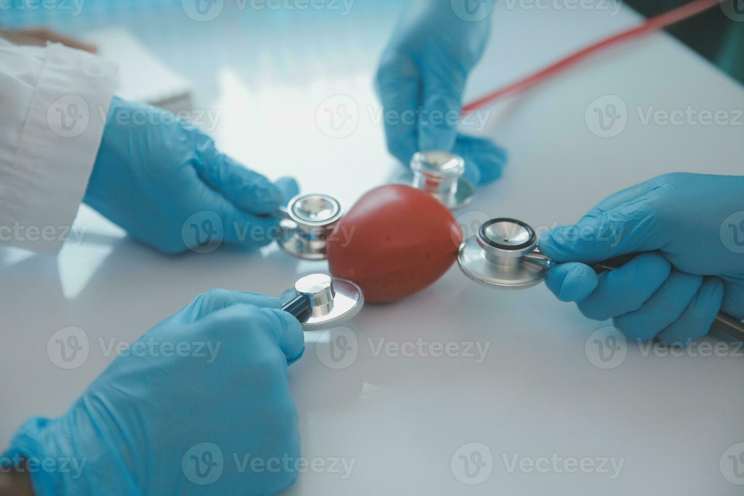 Mature doctors and young nurses stacking hands together at hospital. Close up hands of medical team stacking hands. Group of successful medical doctors and nurses stack of hands. photo
