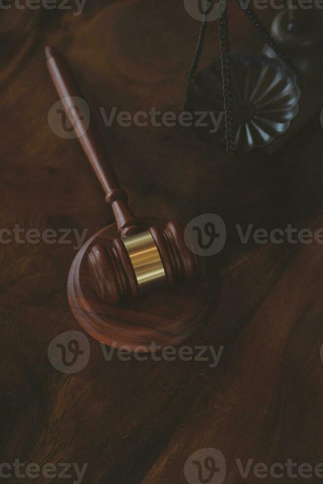 Justice and law concept.Male judge in a courtroom with the gavel, working with, computer and docking keyboard, eyeglasses, on table in morning light photo